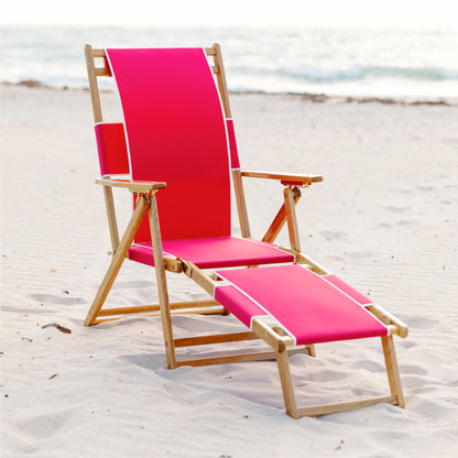 Coastsetter Beach Chair in Jockey Red reclined on the sand with the leg rest extended