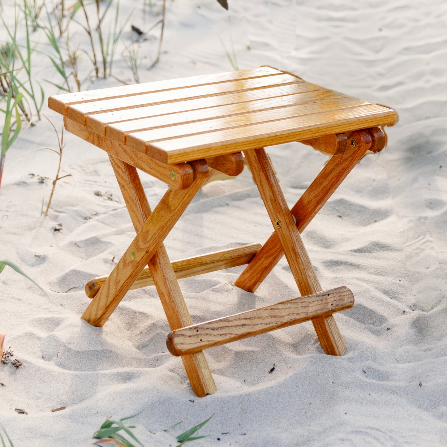 Coastsetter Folding Table in white oak set up on the sand