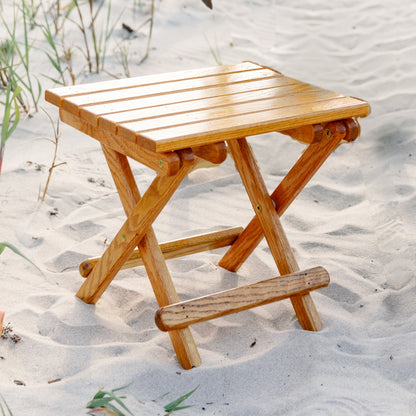 Coastsetter Folding Table in white oak set up on the sand