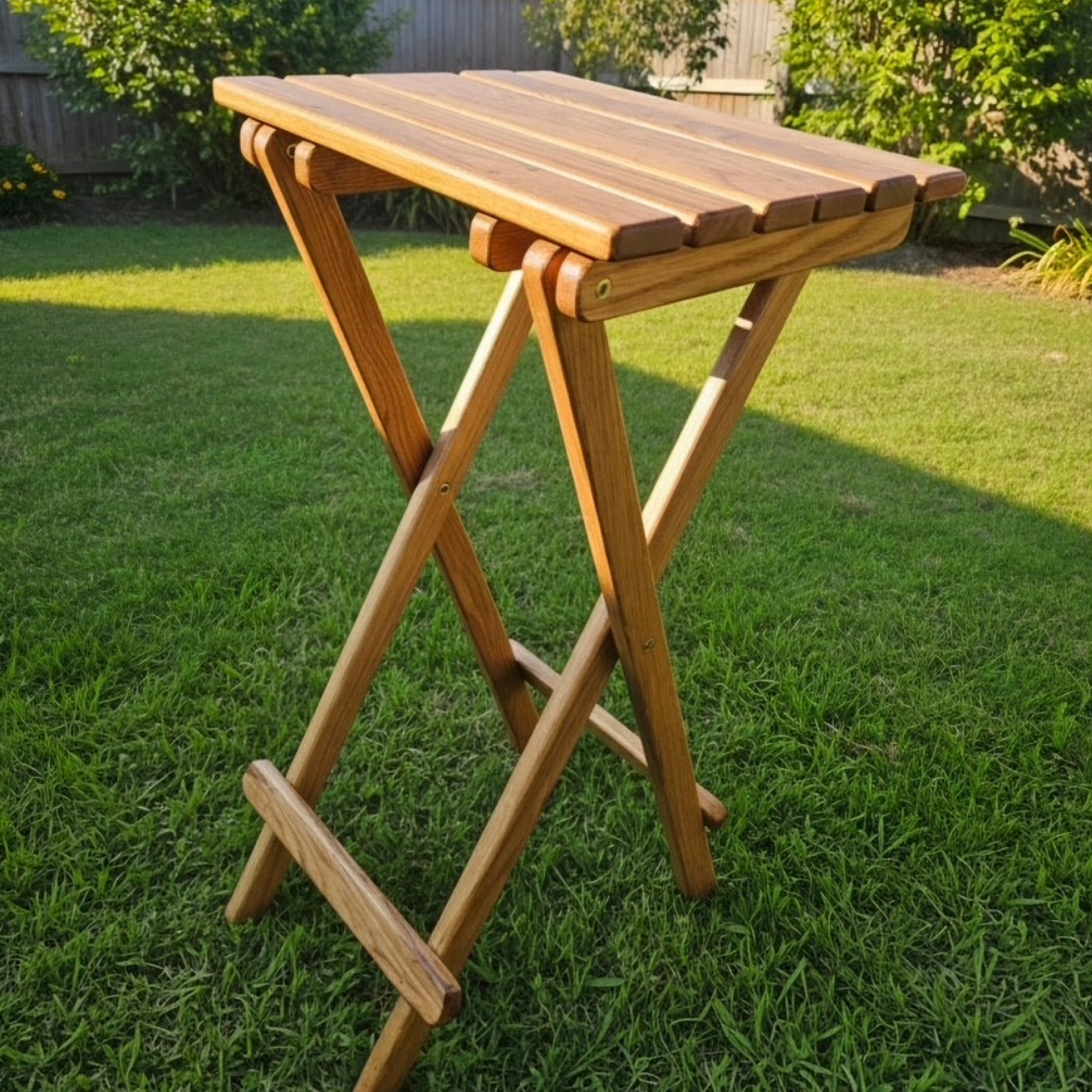 Coastsetter Folding Table in white oak, tall height, set up on grass