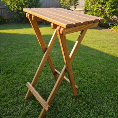 Coastsetter Folding Table in white oak, tall height, set up on grass