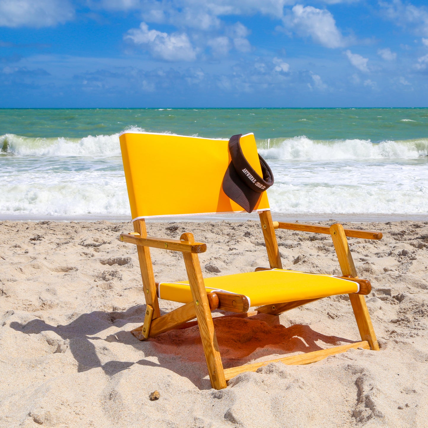 Coastsetter Sand Chair in Sunflower Yellow, sitting low to the sand