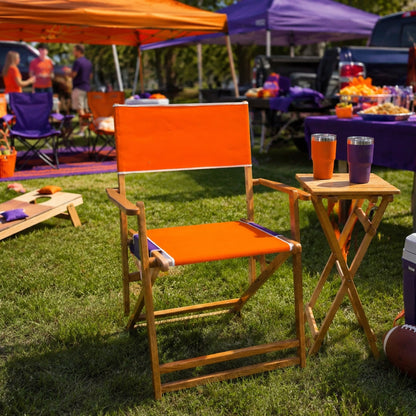 Coastsetter Tailgate Chair in orange and purple at a tailgate, with a matching side table