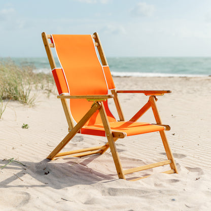 Coastsetter Beach Chair in Tangerine on the sand, upright without a leg rest