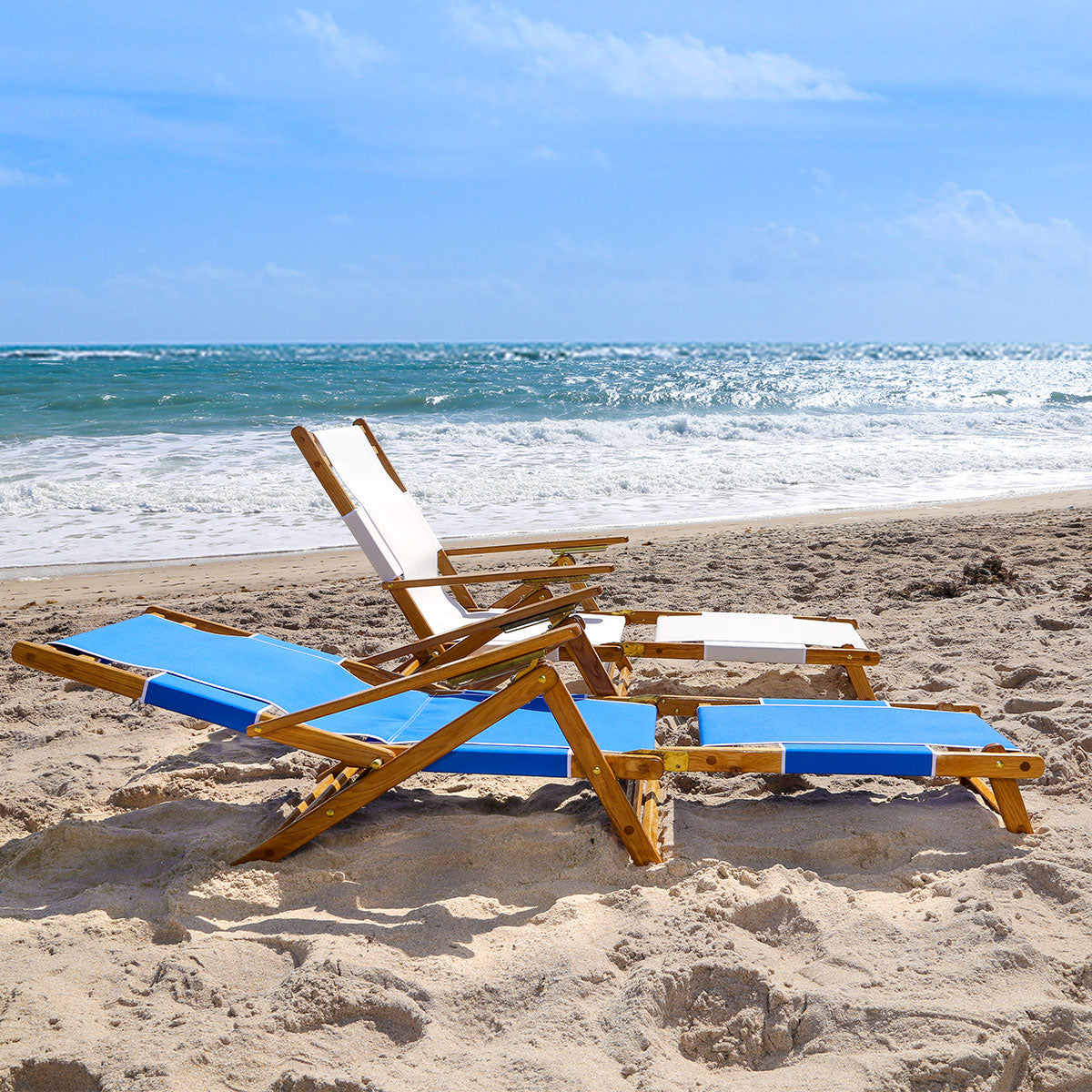 Coastsetter Lounge Chair reclined low on the sand with the leg rest extended