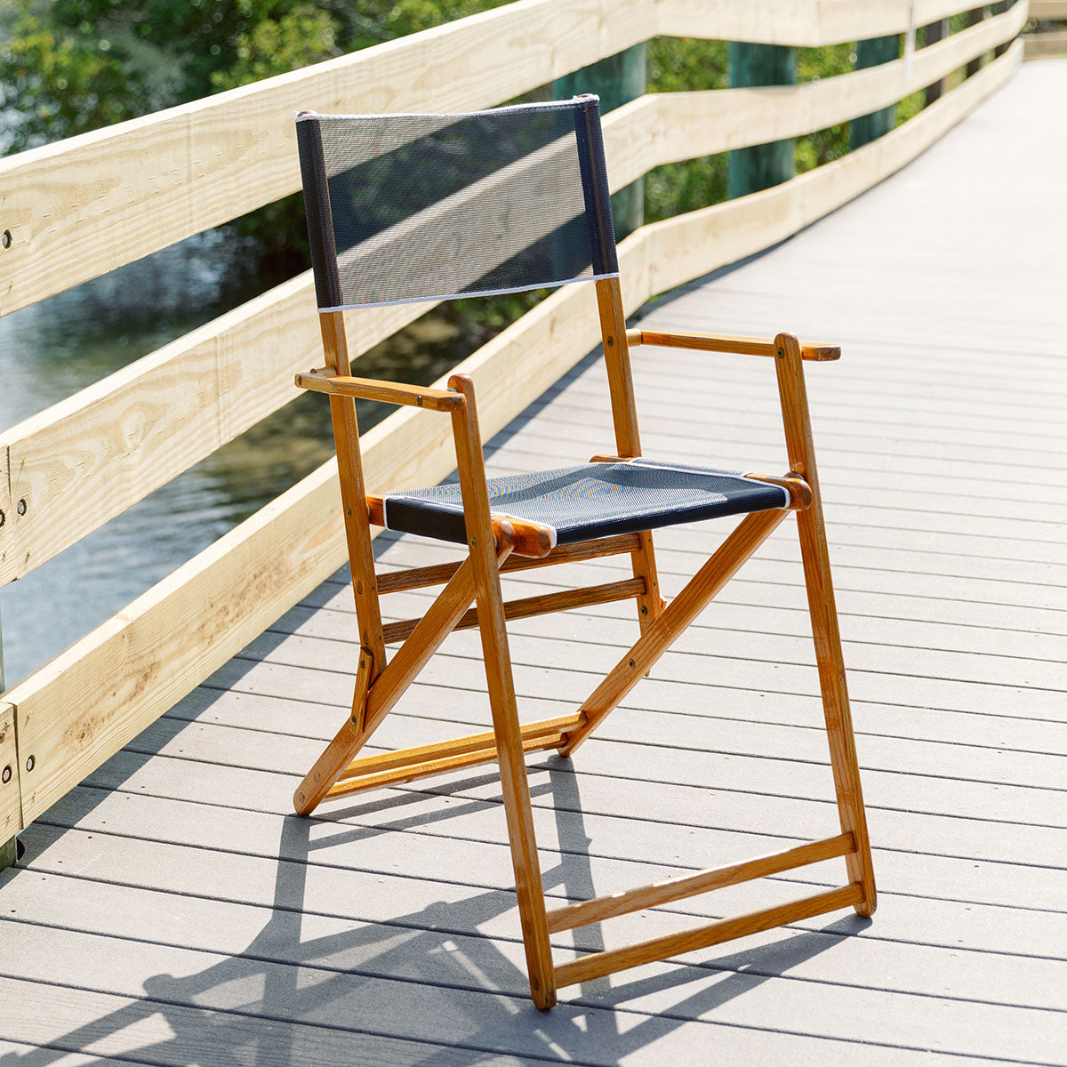 Coastsetter Outer Banks Chair in Navy on a boardwalk above the beach